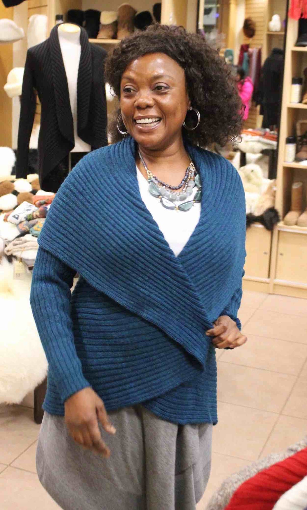 Woman wearing a denim blue ribbed alpaca cardigan sweater