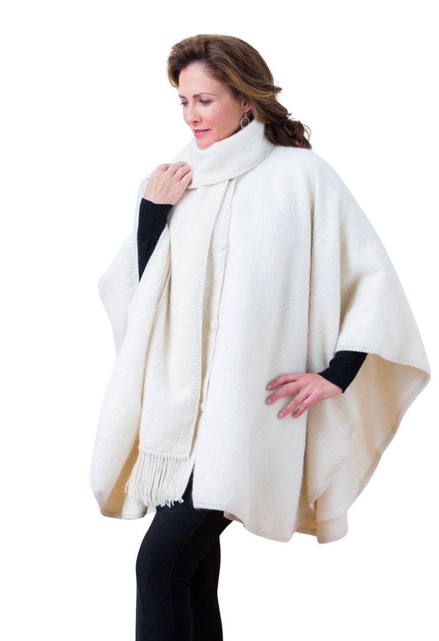 Woman wearing an ivory alpaca cape with matching scarf