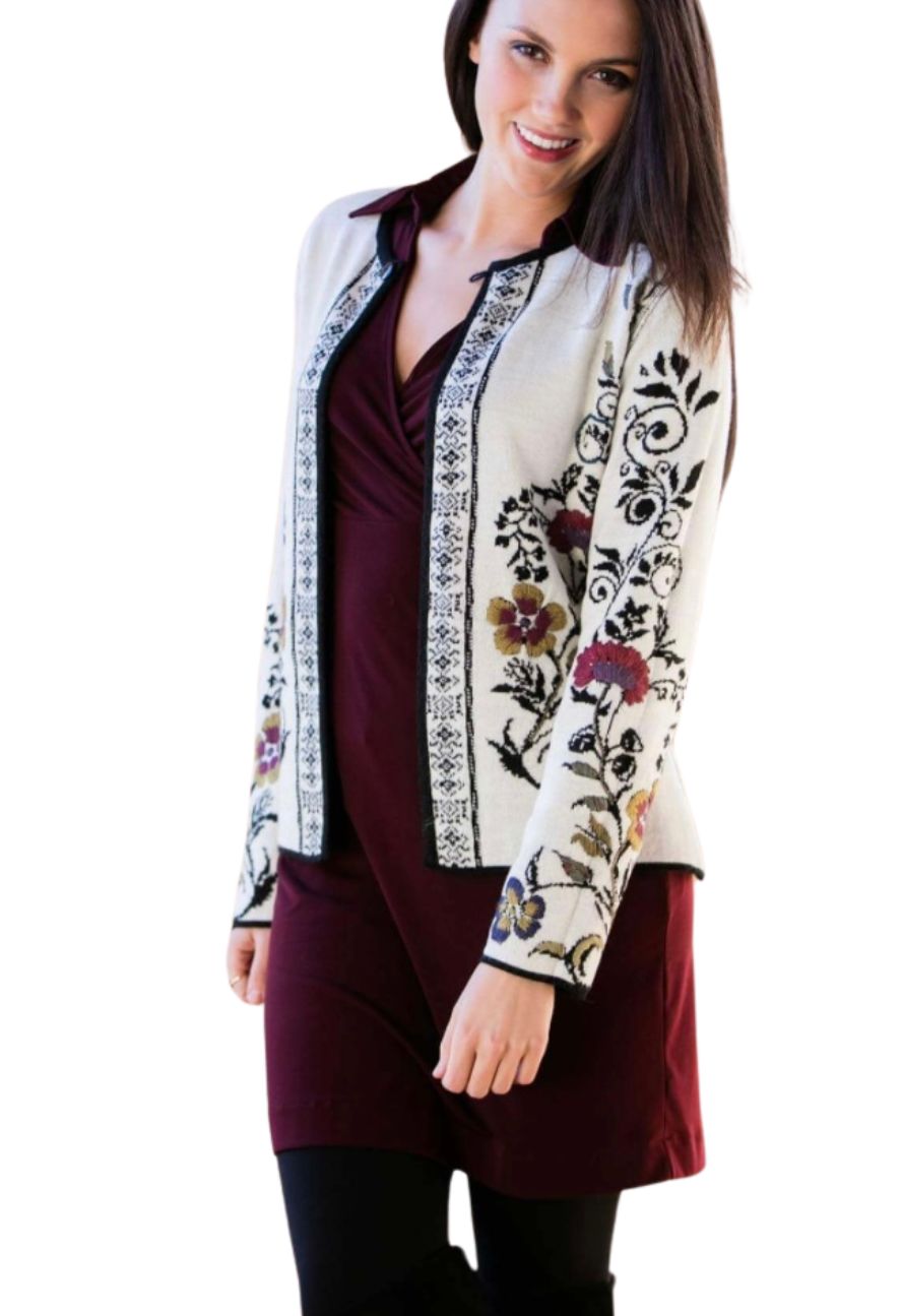 Woman wearing an ivory embroidered alpaca reversible cardigan