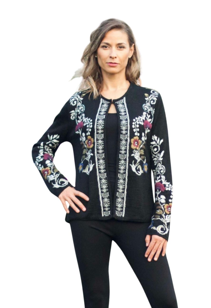 Woman in a black alpaca reversible cardigan with floral embroidery
