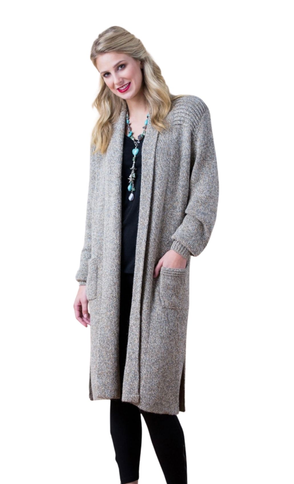 Woman wearing a tan alpaca long sweater, three-quarter view