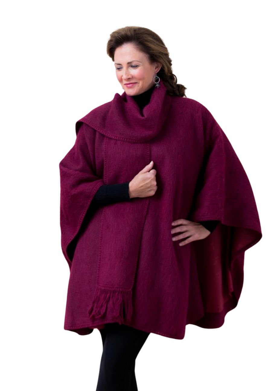 Woman wearing a burgundy alpaca cape with matching scarf