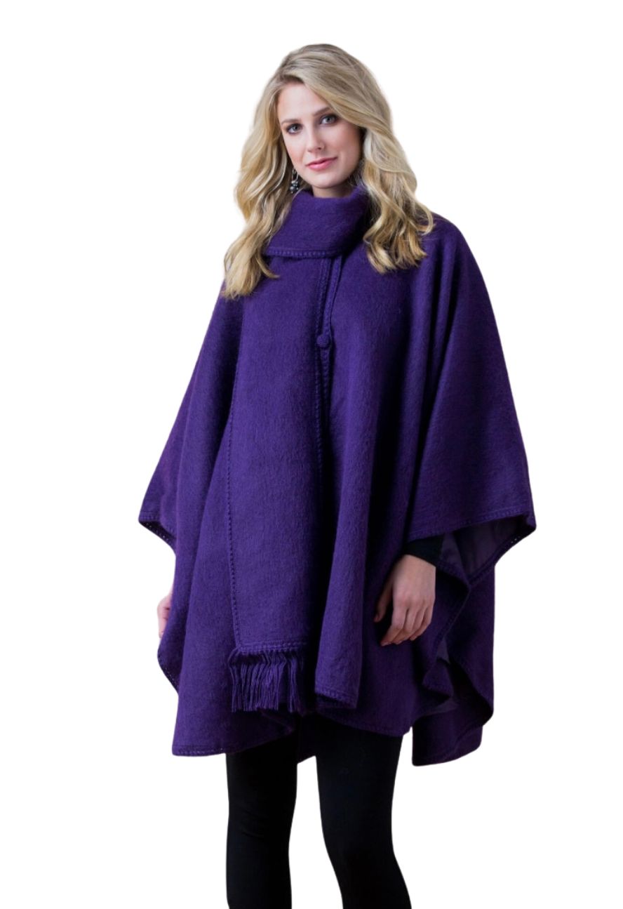 Woman in a purple alpaca cape with scarf, front view