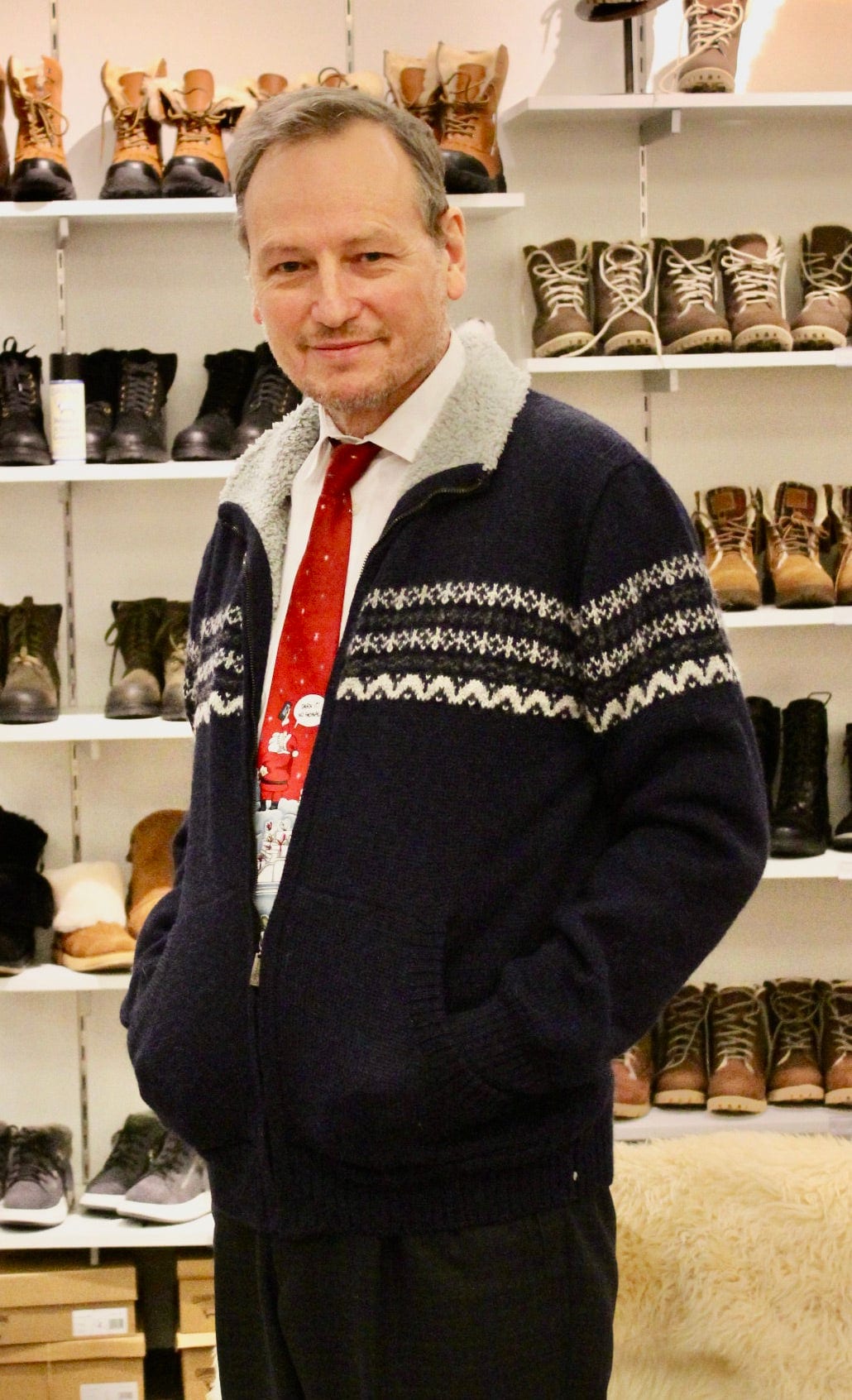 Man in a navy fleece-lined alpaca zip sweater in the shop