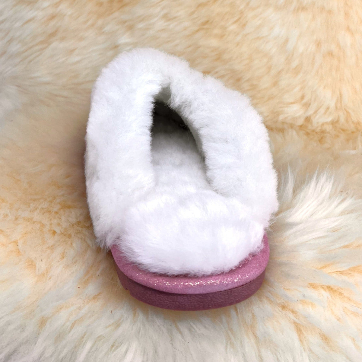 Rose gold sheepskin scuff slipper, back view showing white fleece