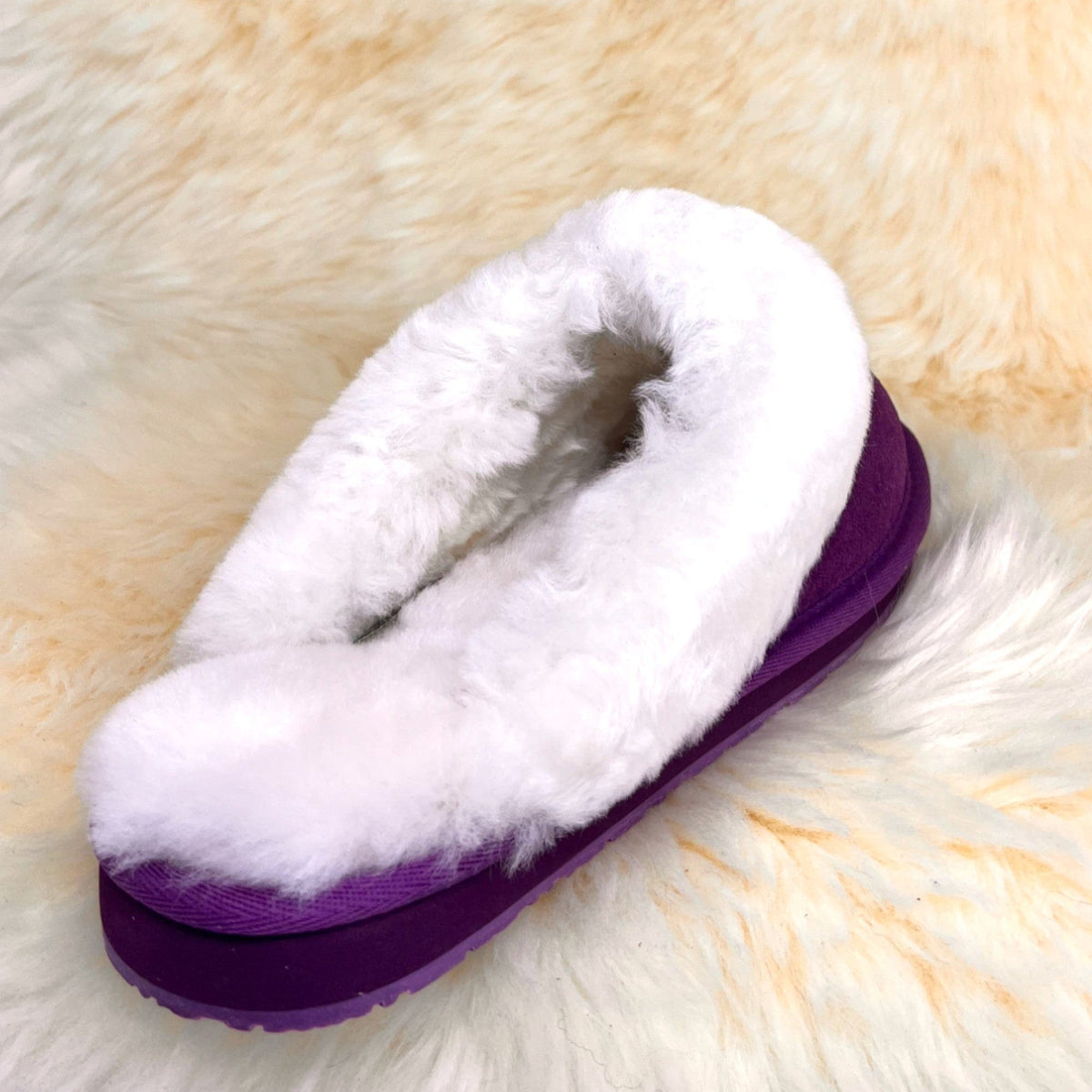 Women's purple sheepskin scuff slipper, rear three-quarter view