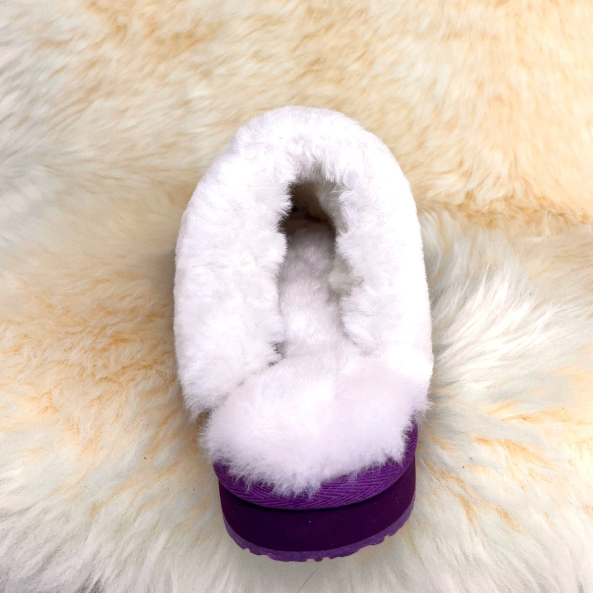 Women's purple sheepskin scuff slipper, back view showing fleece collar