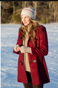 Woman wearing a red baby alpaca hooded toggle coat in the snow
