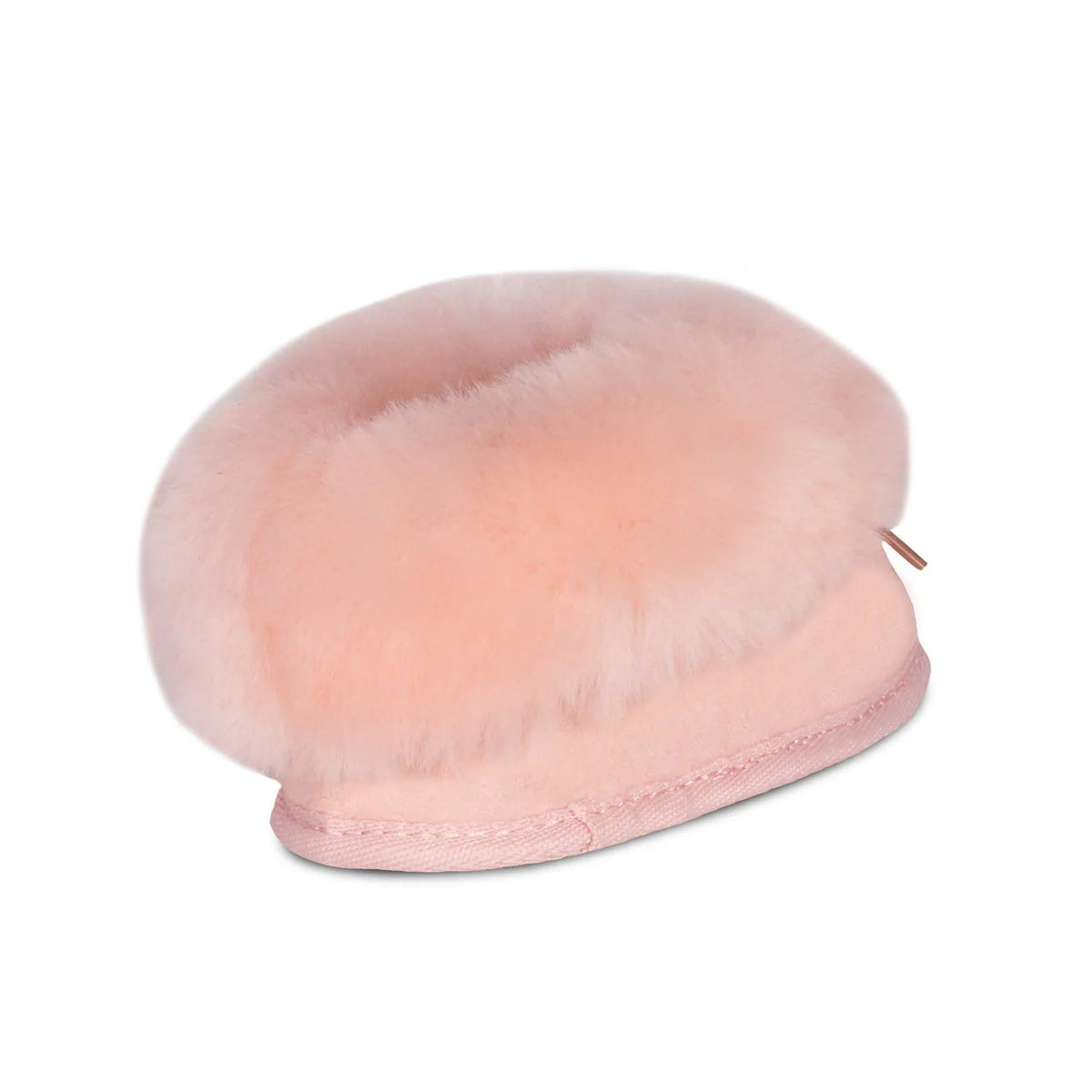 Pink sheepskin baby bootie with plush cuff, angled view
