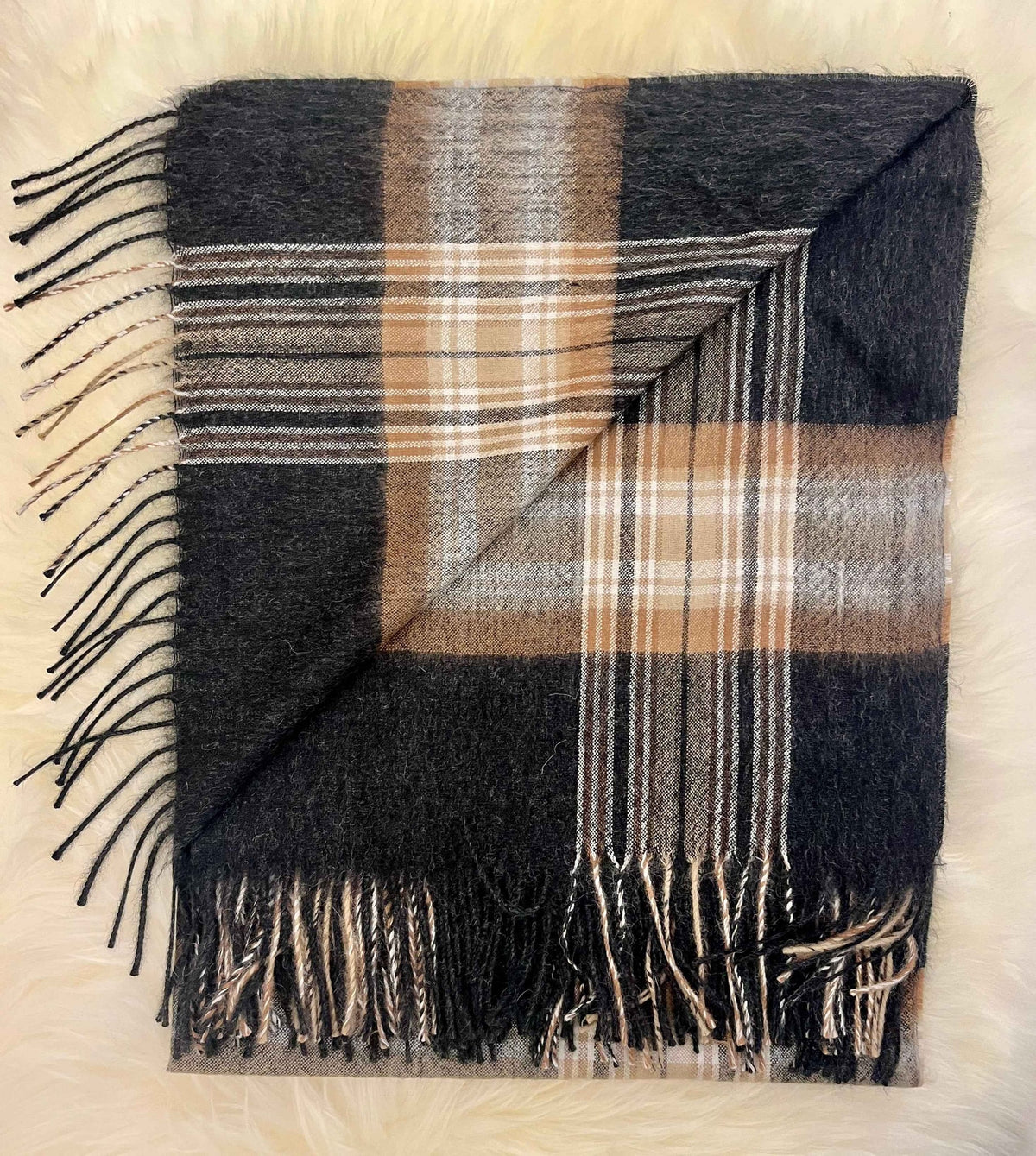 Folded plaid baby alpaca throw with fringe in black, tan and cream