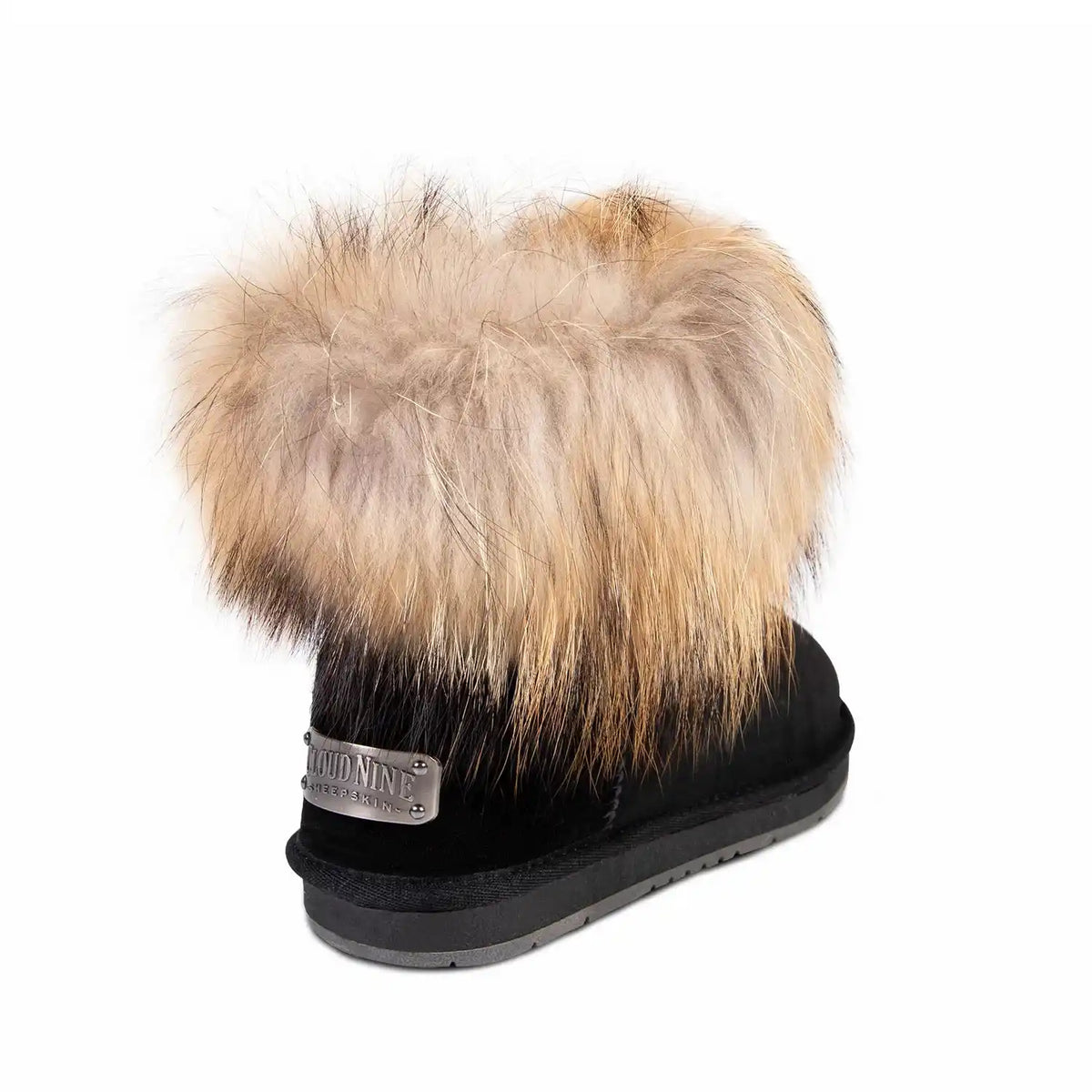 Black boot with a fur pom-pom on a white background