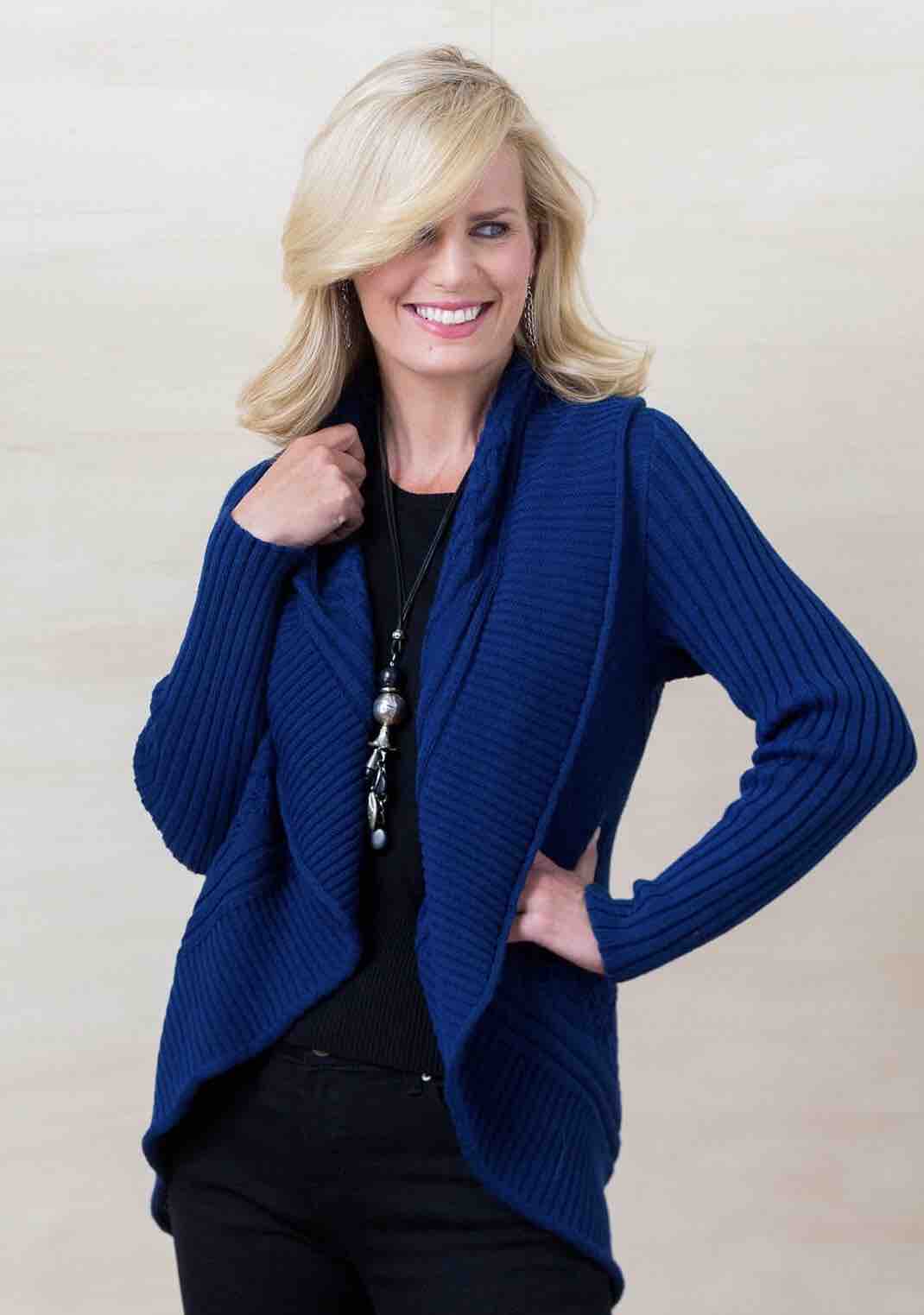 Woman wearing a blue alpaca round cardigan sweater