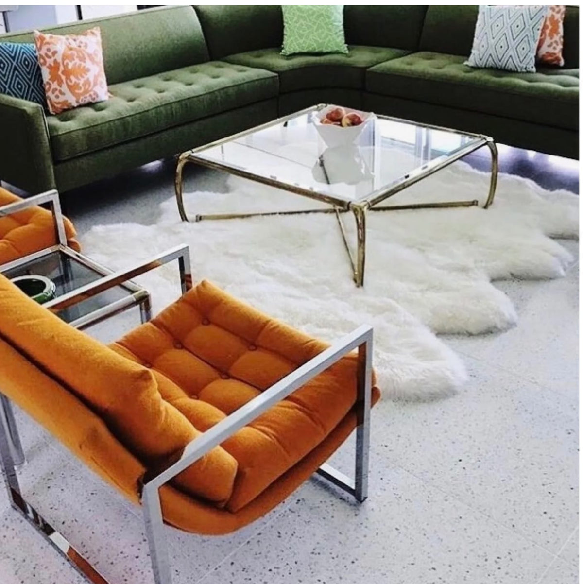 White sheepskin pelts layered on the floor of a modern living room