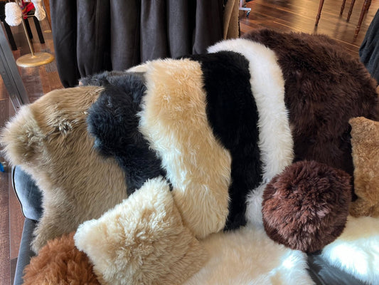 Color_variety of sheepskin pelts laid across the back of a couch